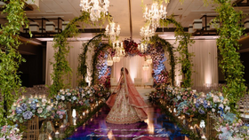 Image of a ARCHING CHANDELIER ENTRANCE WITH HEDGE FLORALS (P)