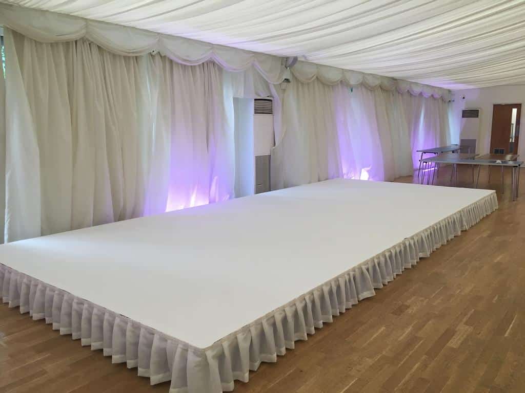 White carpet stage cover 12' x 24' available to rent online