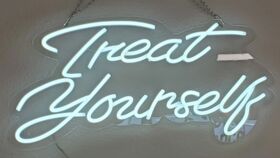 Image of a "Treat Yourself" Neon Sign