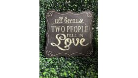 Image of a "All Because Two People Fell In Love" Sign